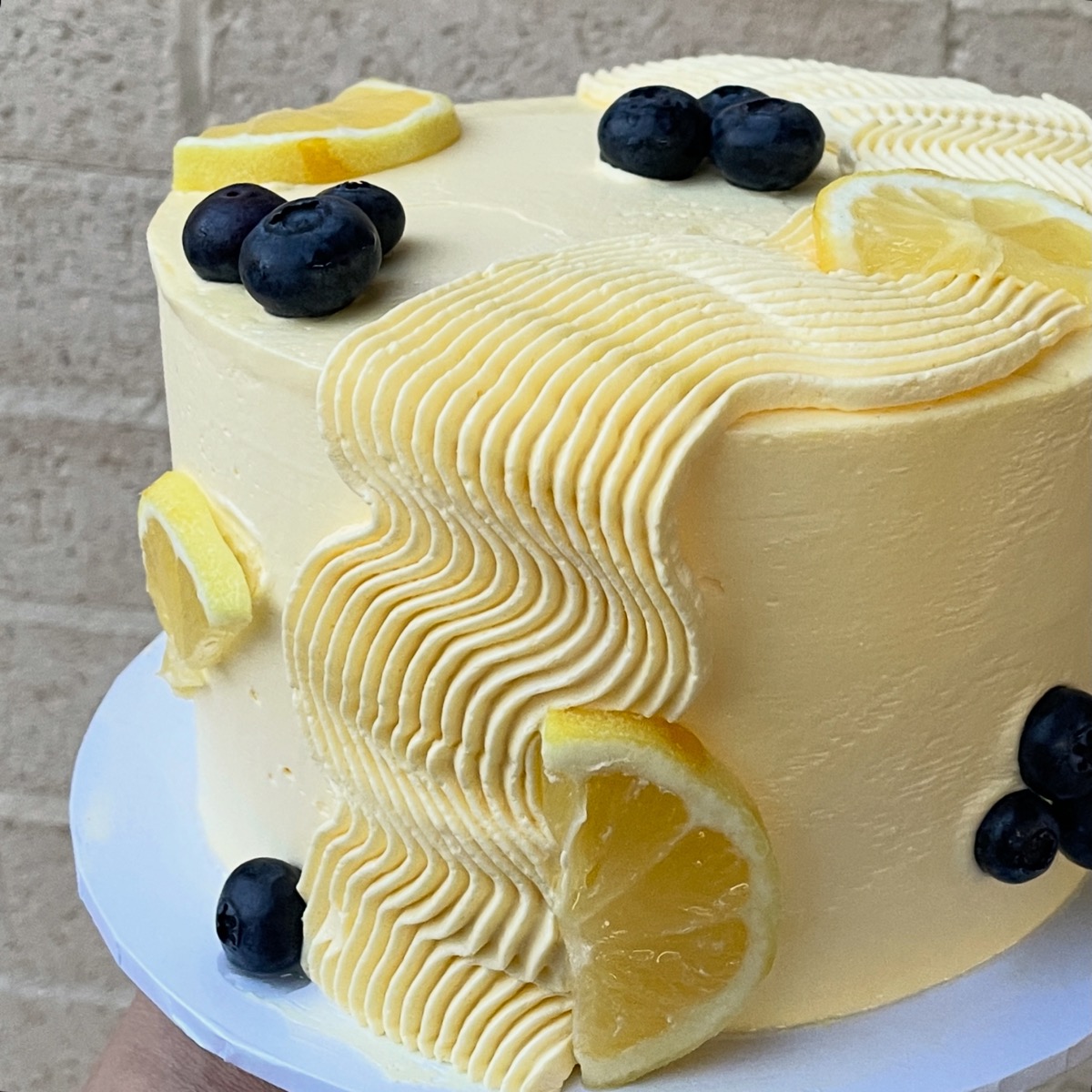 Lemon blueberry cake with fresh fruit and wave texture