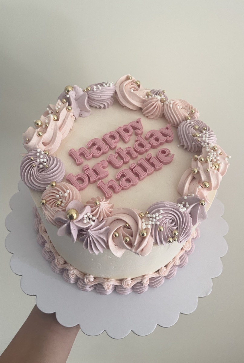 Pink birthday cake with buttercream swirls