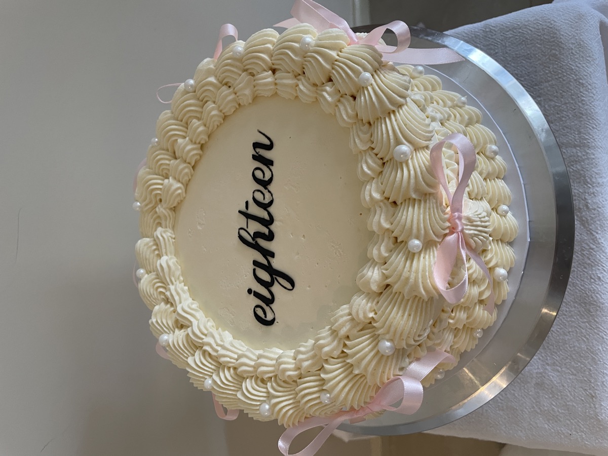 Eighteenth birthday cake with buttercream ruffles and pink bows