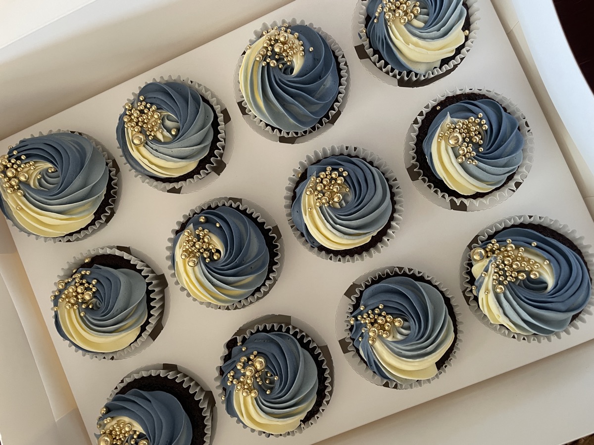 Blue and cream cupcakes with gold bead decorations