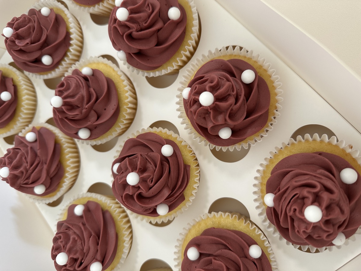 Mauve rose-swirl cupcakes with white pearl decorations