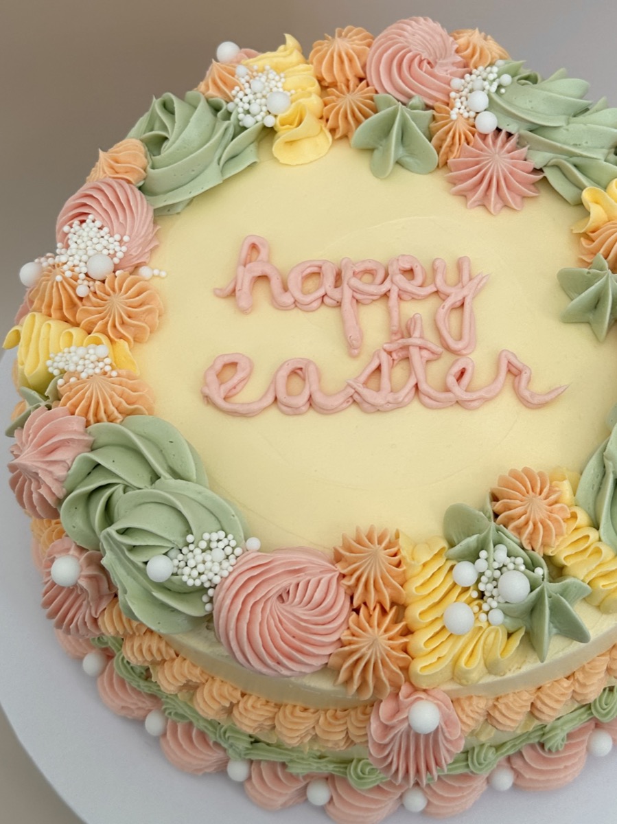 Happy Easter cake with pastel buttercream flowers